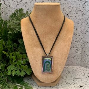Glass swirl pendant necklace in metal setting